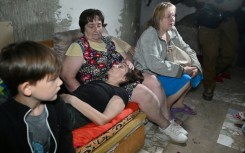 Civilians with their belongings were forced to shelter in a basement amid new air attacks