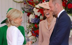 Dressed in a pale pink Dior jacket and dress ensemble, Catherine, Princess of Wales and her husband Prince William greeted the Macrons at an airbase west of London