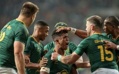 South Africa centre Canan Moodie (C) is congratulated after scoring a try against Italy.