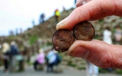 Visitors have been leaving coins in cracks at the Giant's Causeway in Northern Ireland