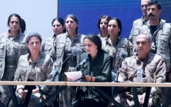 PKK co-chair Bese Hozat reads out a statement before she and 29 comrades destroyed their weapons.
