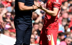 Arne Slot (L) talks to Diogo Jota during Liverpool's pre-season friendly against Sevilla in August 2024