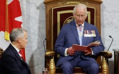 Head of State King Charles III delivers the speech from the throne next to Canada's Prime Minister Mark Carney during the opening of the Canadian parliament in May