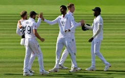 England's Shoaib Bashir (C) celebrates with team-mates Chris Woakes and Joe Root (L) after taking the clinching wicket in a 22-run win over India in the third Test at Lord's