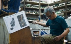An artisan works on a pair of leather boots for the US market at the workshop of Tegep Boots