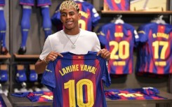 Lamine Yamal with the club's number 10 shirt previously worn by legend Lionel Messi