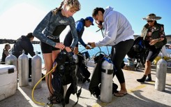 Divers from the environmental group Korero O Te Orau preparing their gear before collecting crown-of-thorns starfish from a reef off Rarotonga in the Cook Islands
