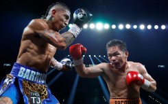 Manny Pacquiao (right) connects with Mario Barrios during their WBC welterweight title fight that ended in a majority draw