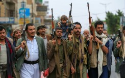 Yemenis brandish their rifles as they chant anti-Israel and anti-US slogans during a rally in the Huthi-run capital Sanaa