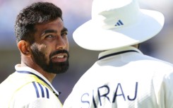 India's Jasprit Bumrah (L) speaks with Mohammed Siraj