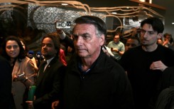 Former Brazilian president Jair Bolsonaro (C) made the speech at Congress, but did not post it from his own social media accounts