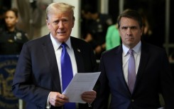 President Donald Trump, flanked by his lawyer Todd Blanche, speaks to reporters at his hush money trial in New York in May 2024