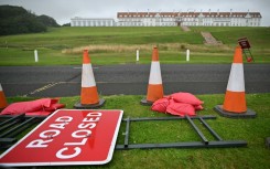 A 'Road Closed' sign is pictured laid on the verge of a road outside the Trump Turnberry hotel