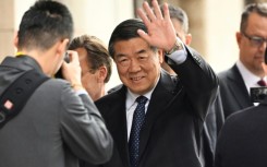 China's Vice Premier He Lifeng (C) waved as he arrived for talks with the US officials in Sweden