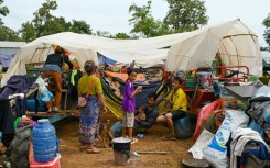 Hundreds of Cambodian evacuees huddled in makeshift tents, surrounded by emergency food rations and their hastily packed clothes