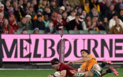 British and Irish Lions' Tom Curry scores a try under pressure from Australia's Joseph-Aukuso Suaalii