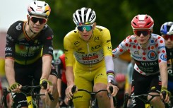 Team Visma riders Wout van Aert (L) and Jonas Vingegaard congratulate Tadej Pogacar at the end of stage 20