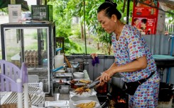 Soeung Chhivling prepares food for customers at her restaurant in Samraong, around 20 kilometres from the border conflict zone