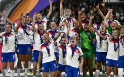 England players lift the trophy after beating Spain on penalties to win the Women's Euro 2025