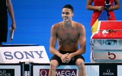 Romania's David Popovici completed a 100m-200m sprint double at swimming's world championships in Singapore