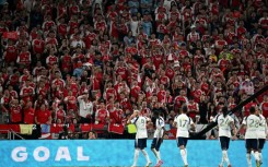 Tottenham Hotspur's players celebrate a goal in front of Arsenal fans during their friendly exhibition football match at the Kai Tak Stadium in Hong Kong on July 31, 2025.