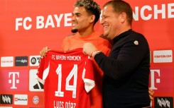 New Bayern Munich forward Luis Diaz (L) smiles alongside sporting director Max Eberl at his unveiling on Thursday.