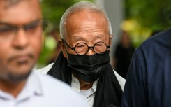 Malaysian hotel tycoon Ong Beng Seng (C) leaves the State Court in Singapore, in a rare corruption case in the city-state