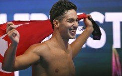 Tunisia's Ahmed Jaouadi grabbed gold in the 1,500m freestyle ahead of Germany's Sven Schwarz and Olympic champion Bobby Finke