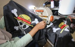 A factory owner says plain-clothes police raided his facility to stop production of the emblem