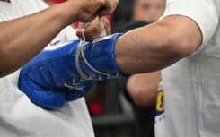File picture of a trainer lacing up the gloves of Filipino boxer Manny Pacquiao