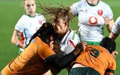 Taking guard: Australia’s Faliki Pohiva (L) and Samantha Wood tackle Carys Cox (C) of Wales in a Test in Sydney on August 1. At the World Cup, the players will wear high-tech gum shields