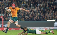 Australia's Harry Wilson (L) skips out of Manie Libbok's tackle to score in Johannesburg
