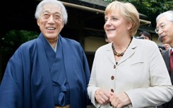 Sen Genshitsu, pictured in 2007 meeting Germany's then chancellor Angela Merkel, stressed the calming effects of tea culture