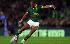 South Africa fly-half Manie Libbok takes a kick at goal.