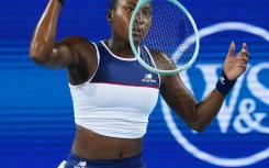 Frustrated Coco Gauff tosses her racquet during her quarter-final loss to Jasmine Paolini at the ATP-WTA Cincinnati Open