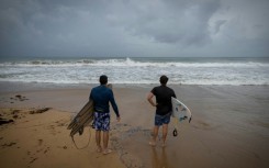Surfers in Luquillo, Puerto Rico survey conditions with Hurricane Erin approaching, the first of what is expected to be a particularly intense Atlantic season