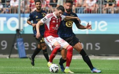 Olivier Giroud (R) scored for Lille in their draw with Brest on his return to Ligue 1 after 13 years away