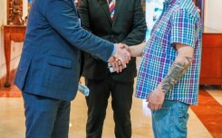 US Senator Chris Van Hollen (L) shakes hands with Salvadoran migrant Kilmar Abrego Garcia (R), a US resident wrongfully deported to his home country, at a hotel in San Salvador