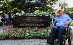 Ron Turcotte, jockey of 1973 Triple Crown winner Secretariat, poses for photos at Belmont Park in 2012