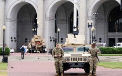 Members of the National Guard stand watch outside of Union Station in the US capital Washington, while President Donald Trump has threatened to deploy more troops to other Democratic-led cities like Baltimore and Chicago