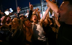 Oasis fans rock out last month during the band's first tour in 16 years in Cardiff, Wales