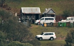 Australian police searched buildings for a gunman suspected of killing two officers