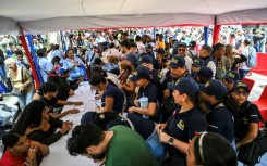 Thousands line up to join the civilian militia in Venezuela after President Nicolas Maduro warned of possible US invasion
