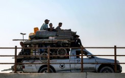 Displaced Gazans head south along a coastal road as the Israeli military gears up for a major new operation in the territory's north