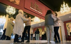 Women with Parkinson's disease dance in a tango therapy session in Buenos Aires