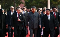 Russia's President Vladimir Putin walks with China's President Xi Jinping and North Korea's leader Kim Jong Un before a military parade marking the 80th anniversary of victory over Japan and the end of World War II, in Beijing’s Tiananmen Square