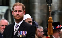 Britain's Prince Harry, the Duke of Sussex, looks on as his father leaves Westminster Abbey after being crowned King Charles III in 2023
