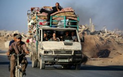 Palestinians flee south on the coastal road in central Gaza last month. Most Gazans have been displaced at least once during the war