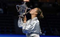 Aryna Sabalenka kisses the US Open trophy after retaining her title with a straight sets defeat of Amanda Anisimova
