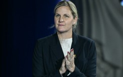 The President of the International Olympic Committee Kirsty Coventry reacts on the podium of the women's 100m backstroke swimming event during the 2025 World Aquatics Championships in Singapore